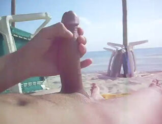Boy draining his gigantic prick in the beach